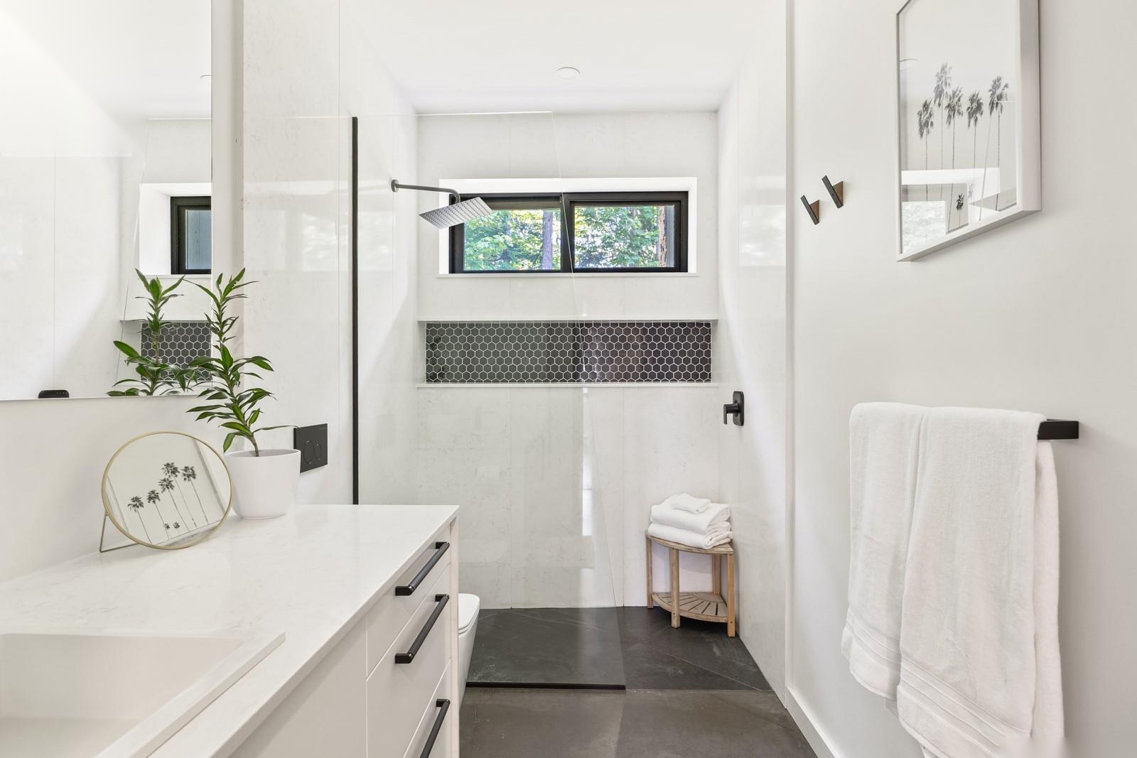 Modern bathroom with hex-tile niche, walk-in shower, and high-end finishes