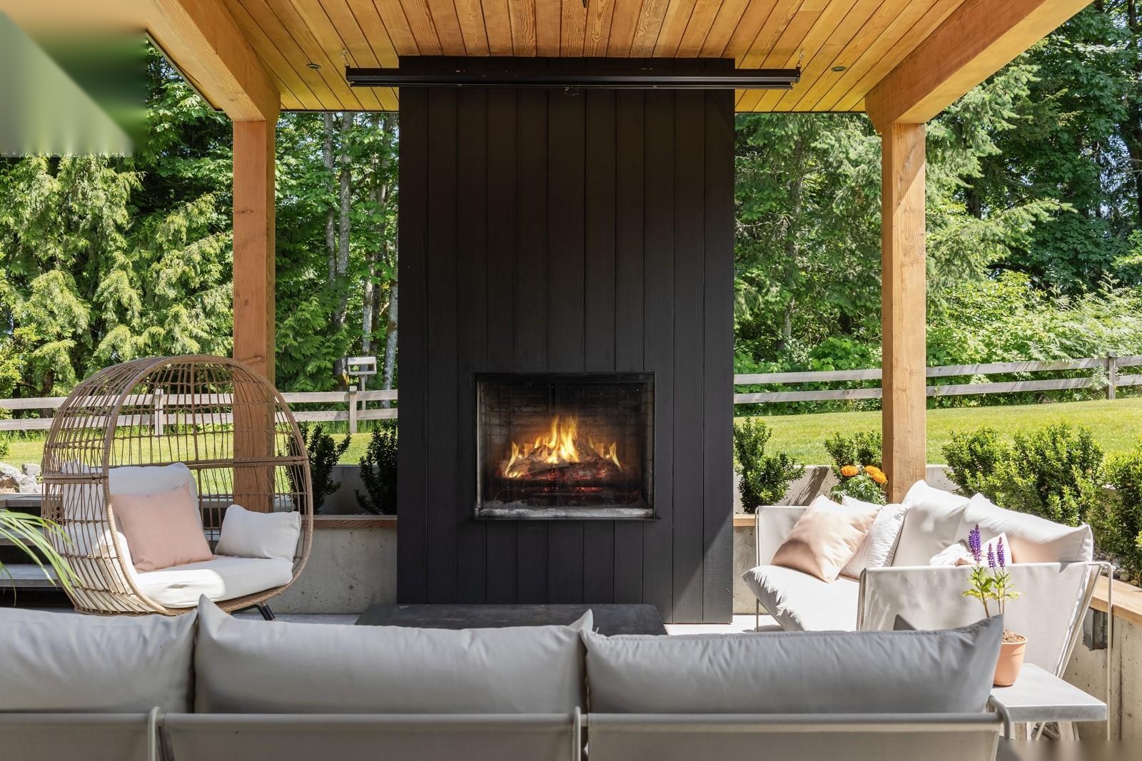 Outdoor living area with cedar pergola, gas fireplace, and lounge seating